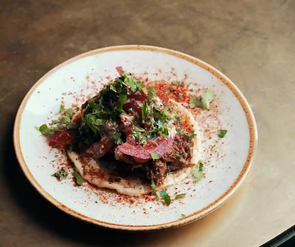 A delicious taco with garnish on a plate, highlighting the handmade dishes at Temper Restaurant in Soho, City & Covent Garden